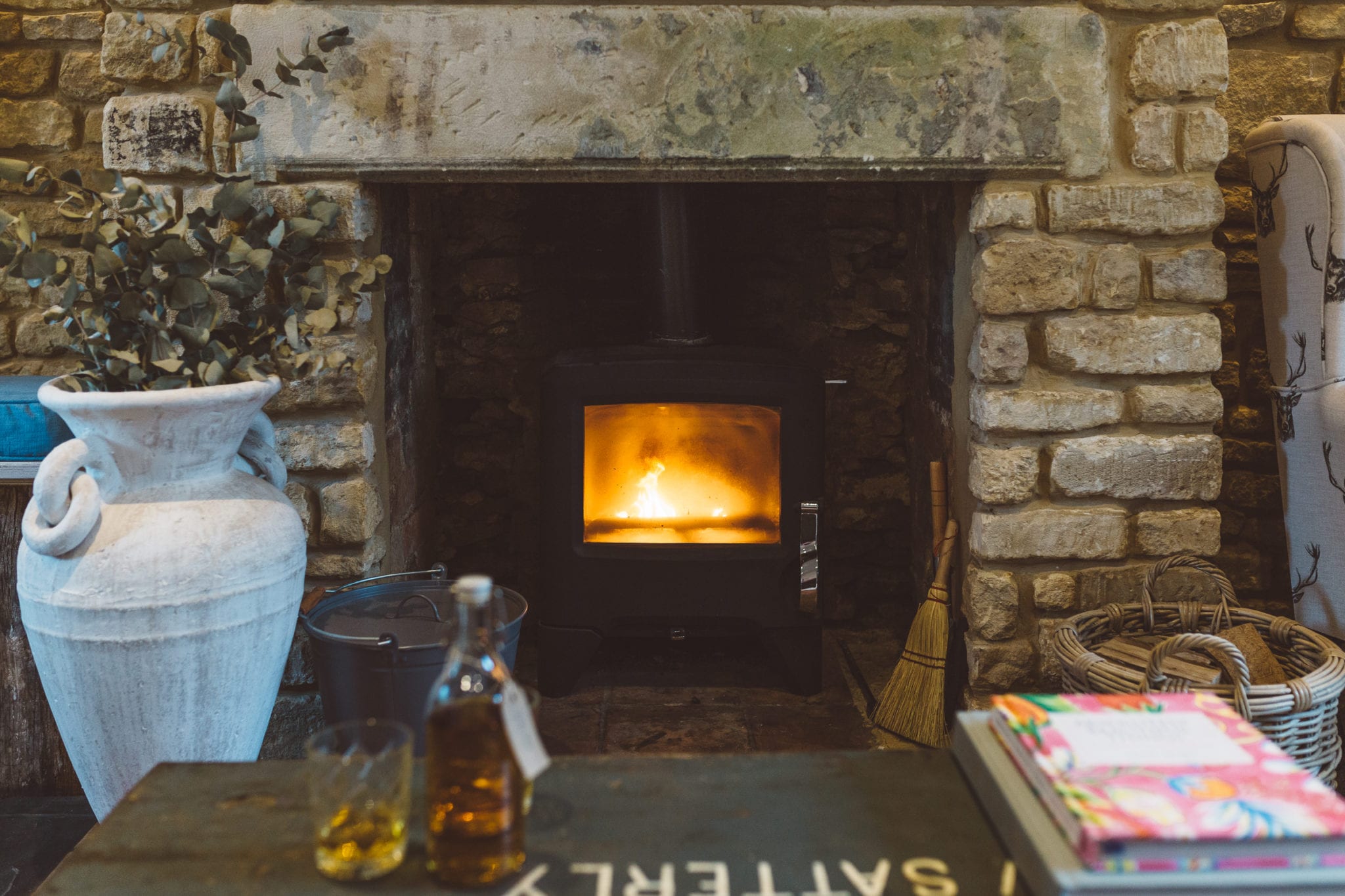 A woodburner fireplace in a quaint old cottage