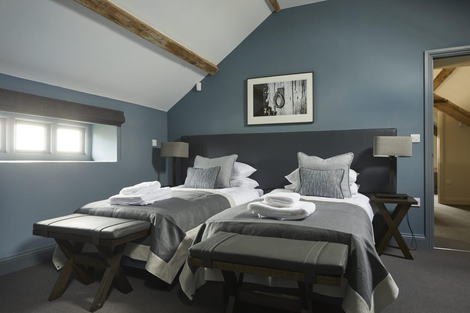 The Stable twin bedroom with white ceiling