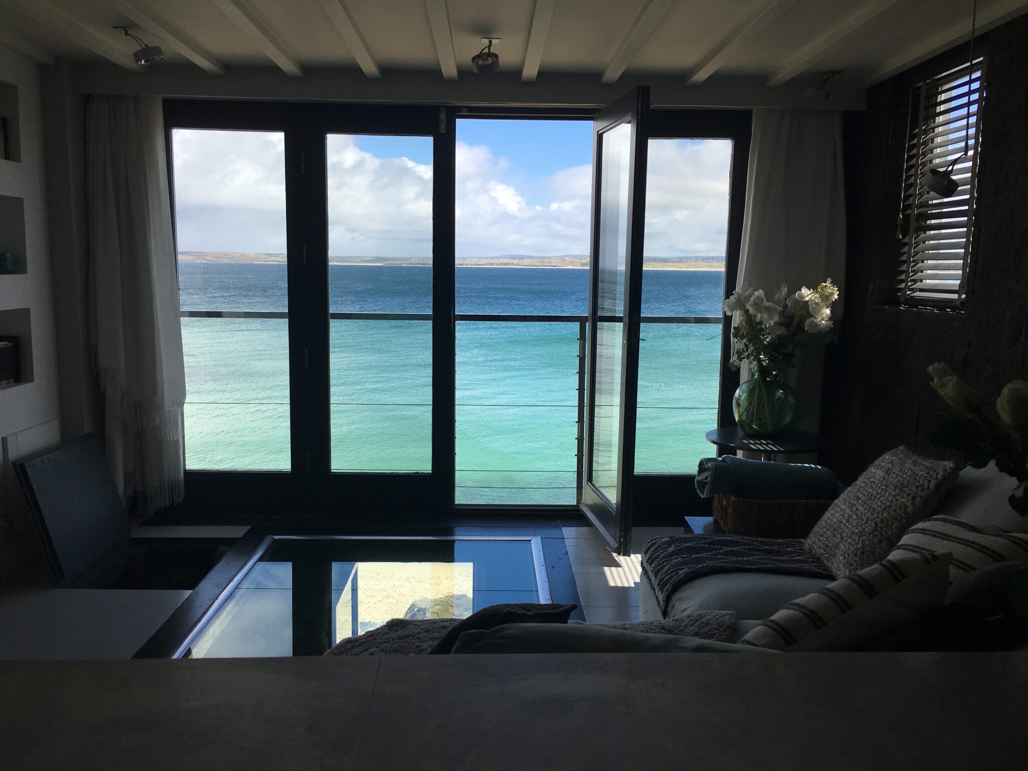 View of the blue sea from an apartment living room