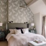 Bedroom with high ceilings and patterned wallpaper