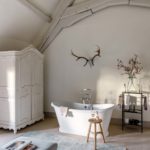 Bedroom with high beam ceilings and rolltop bathtub