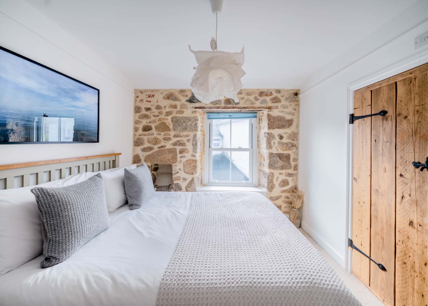 Bedroom with exposed stone walls