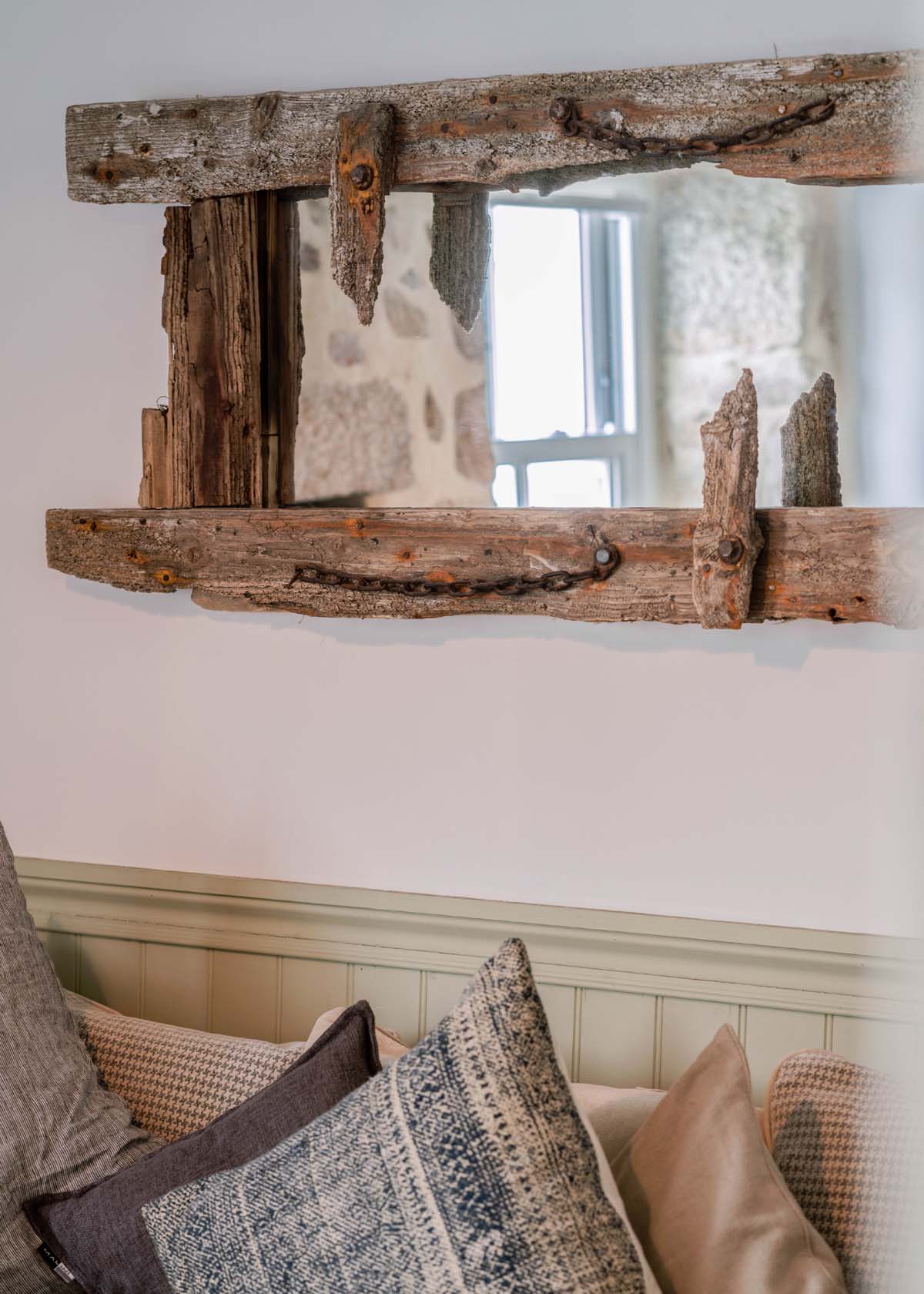 A mirror with a driftwood frame
