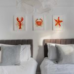 Twin beds with grey cushions