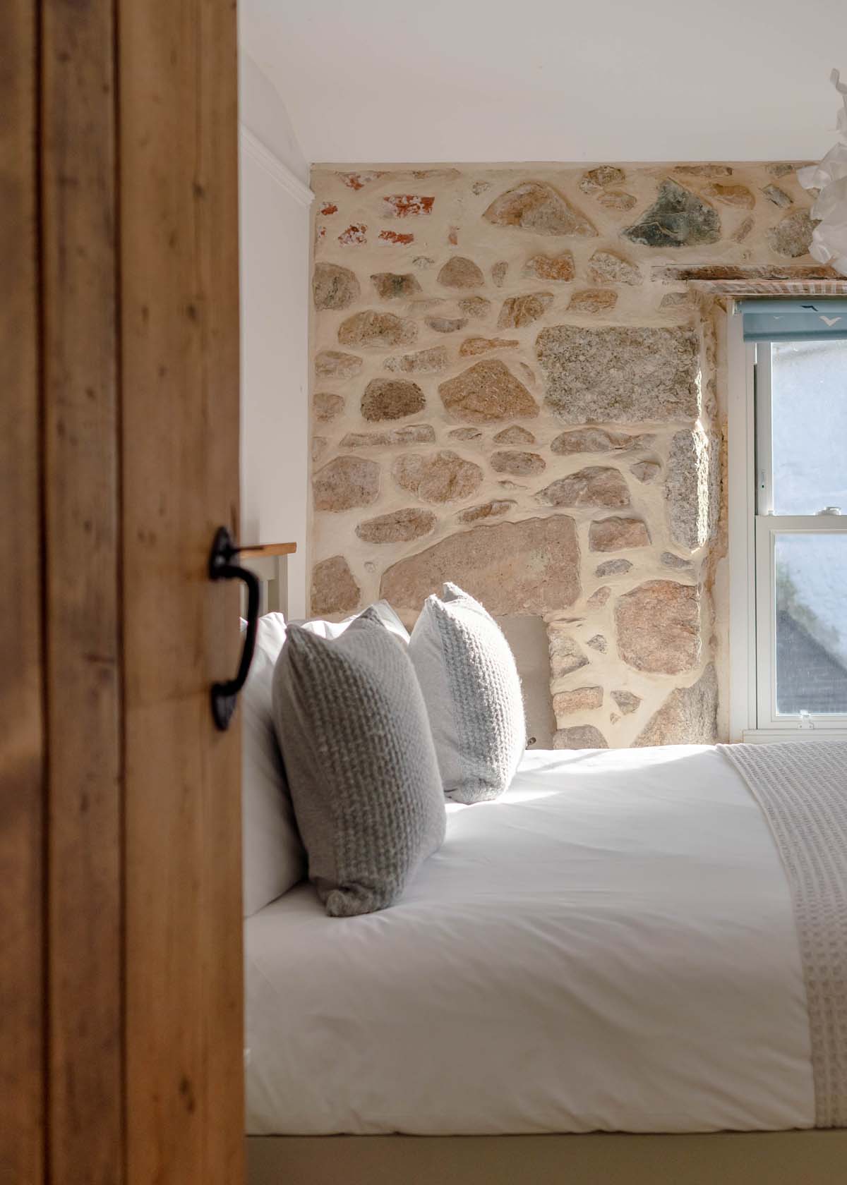Double bedroom with exposed stone walls