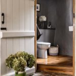 Country house loo with large wooden door