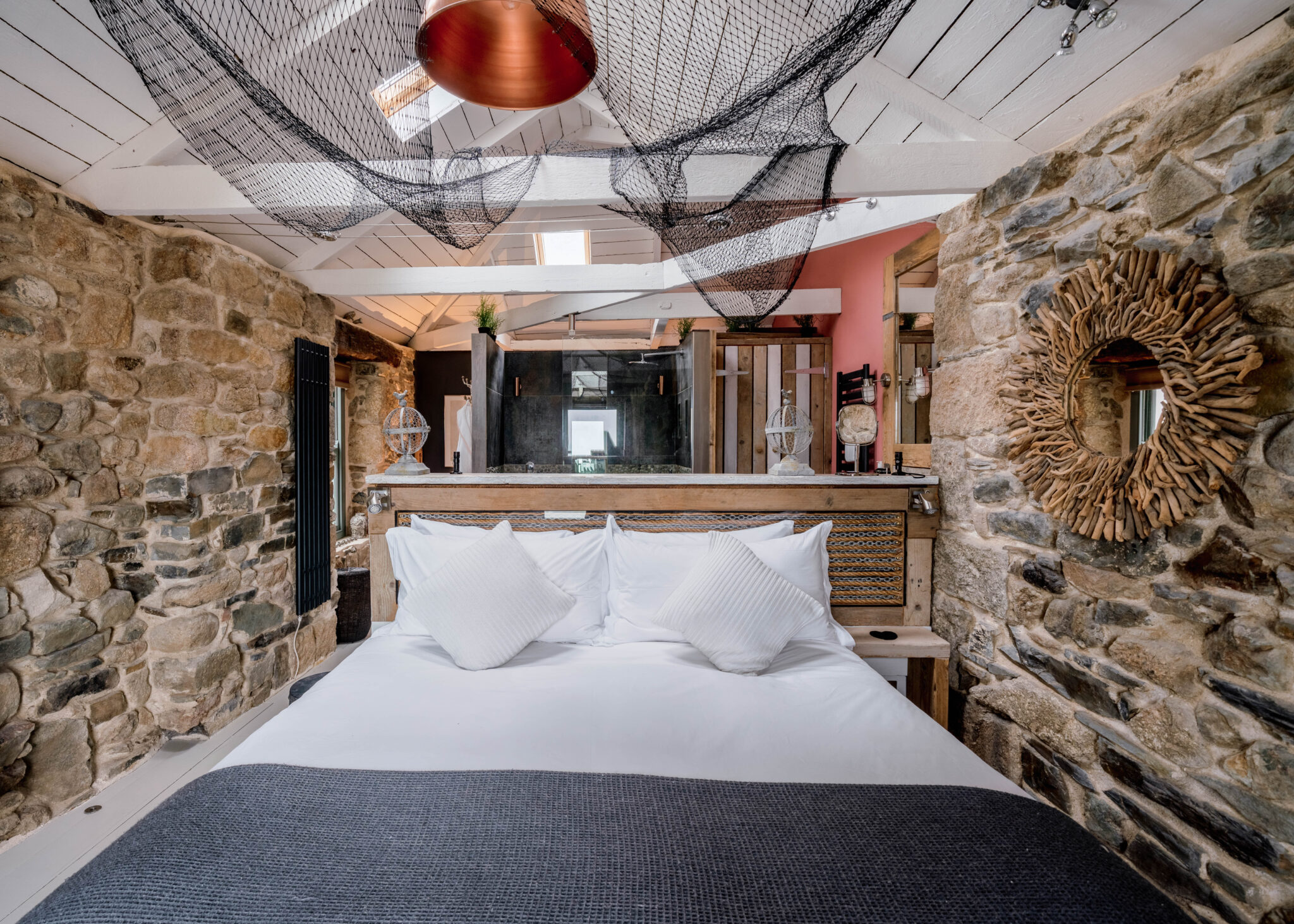 Cottage bedroom with exposed stone walls