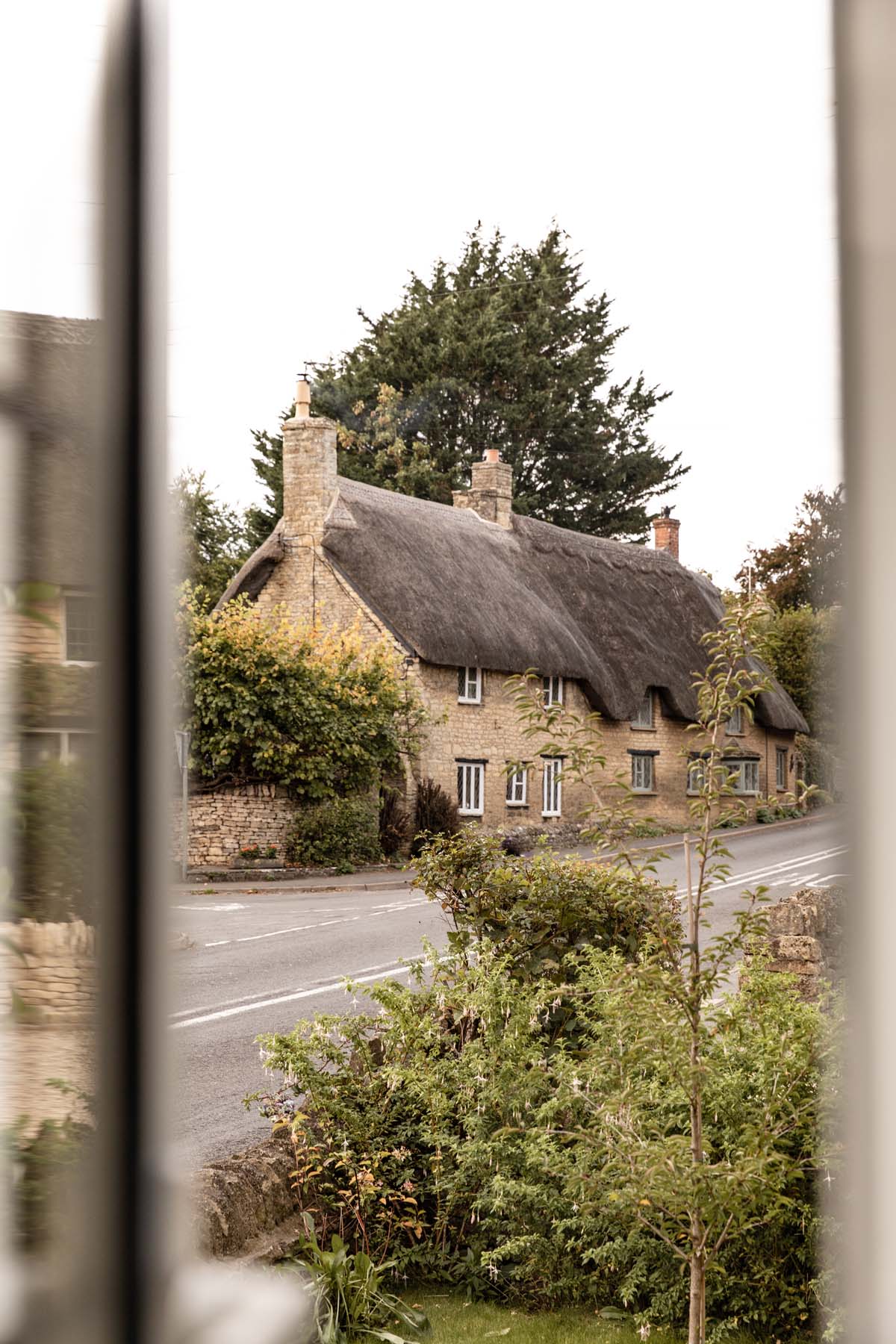 Street view of thatched cottages in Long Compton
