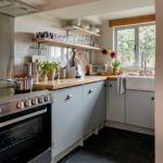 Small cottage kitchen with blue cabinets