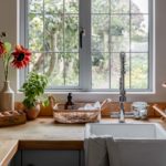 Cottage kitchen windowsill with flowers and toiletries
