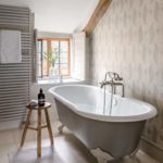 Neutral bathroom with grey rolltop bath