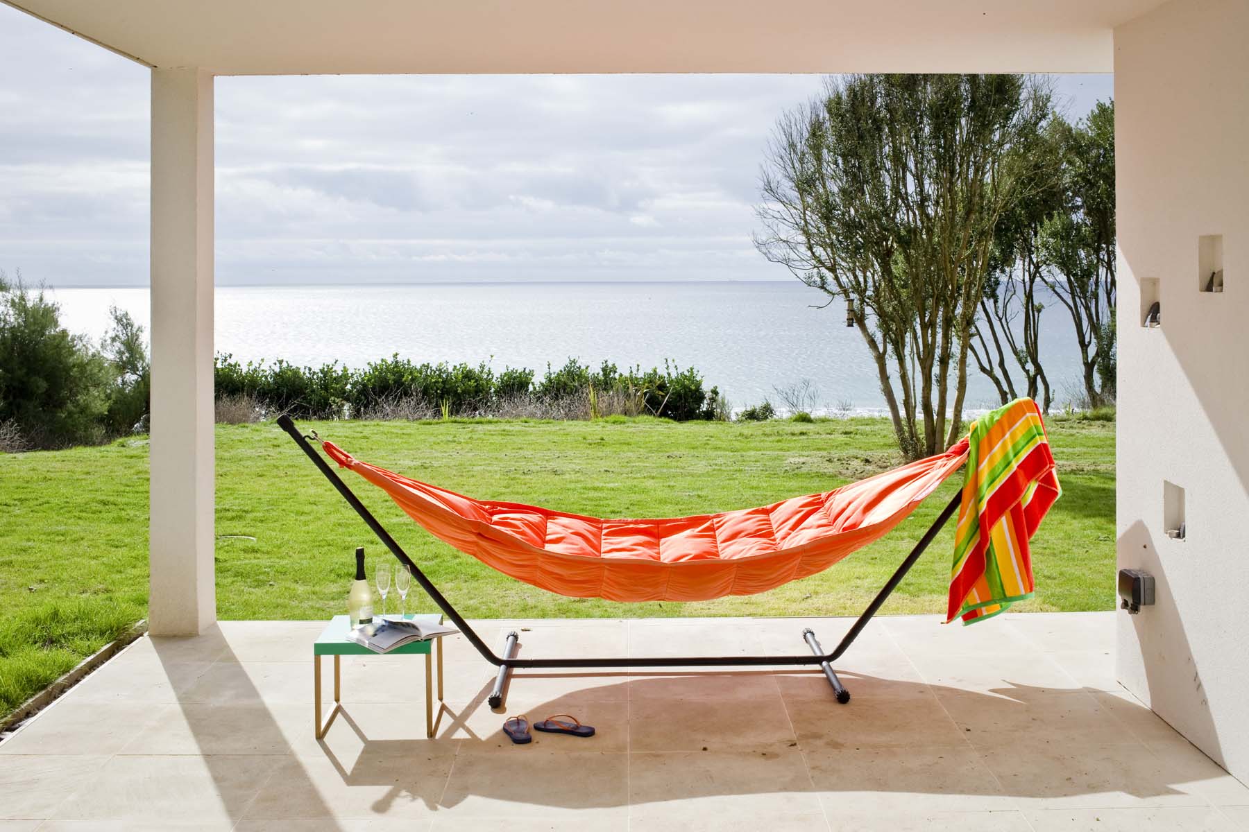 A large orange hammock with sea view