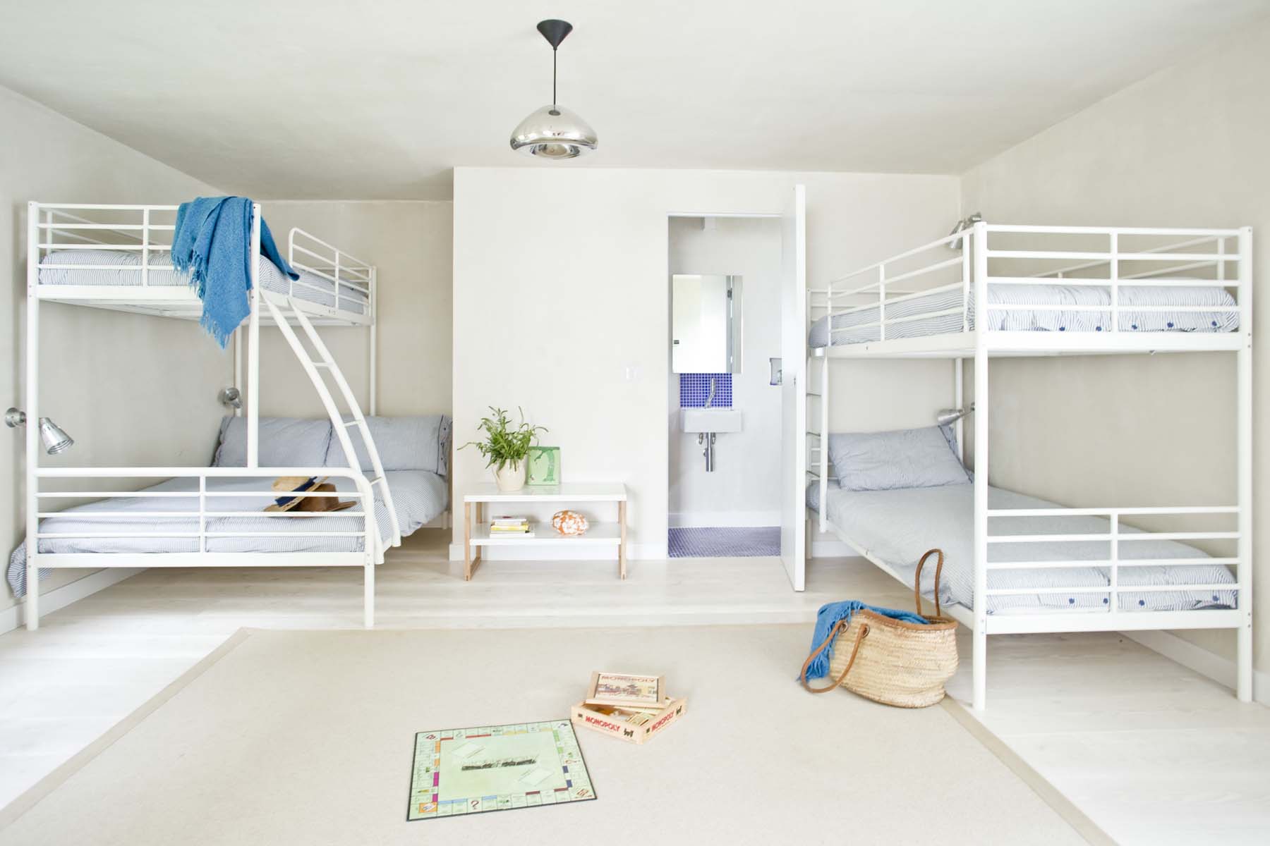 A modern kids room with bunk beds and games