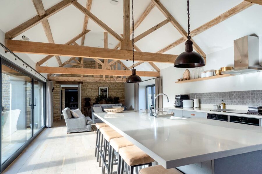 A large open plan kitchen area with exposed wooden beams