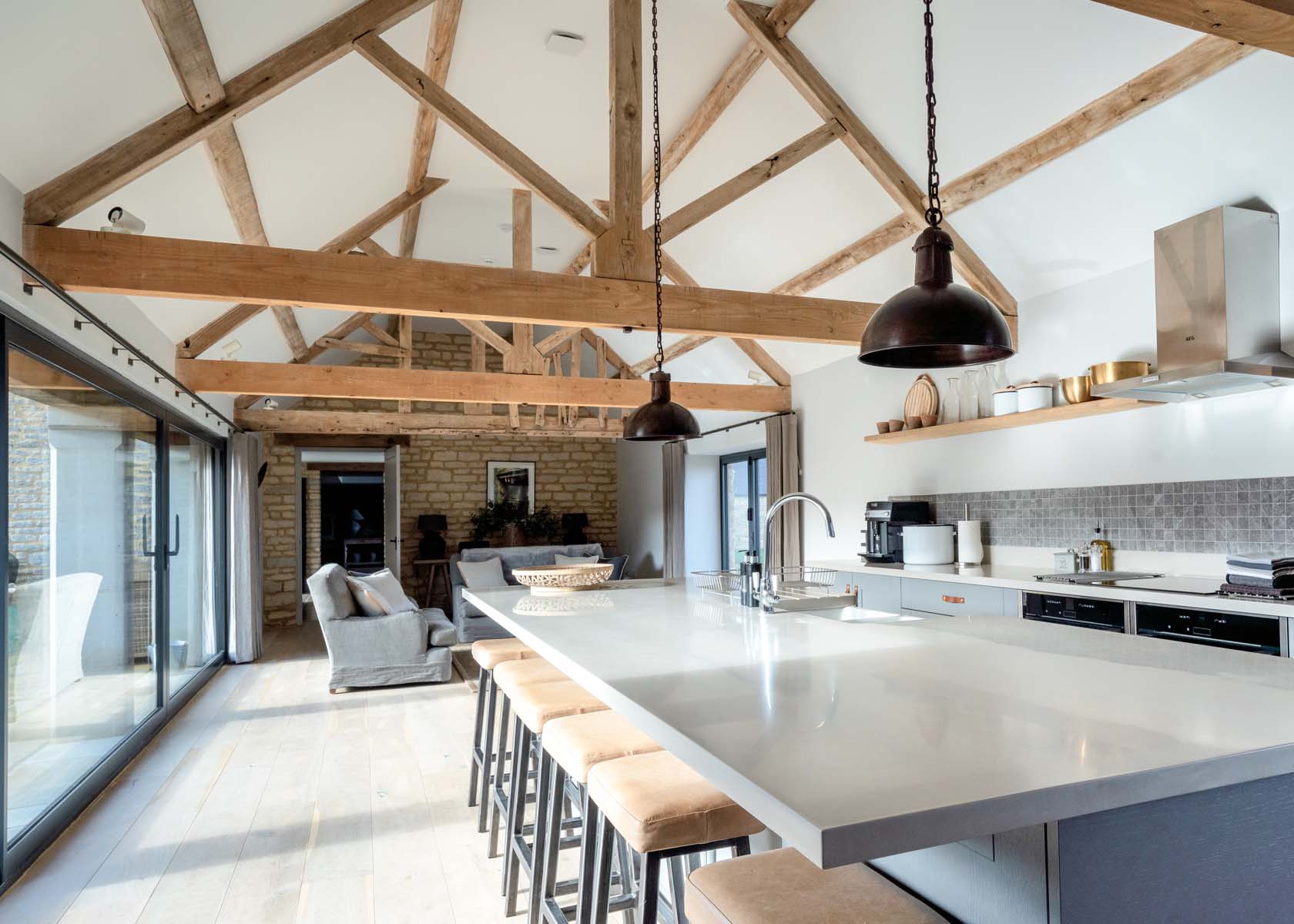A large open plan kitchen area with exposed wooden beams