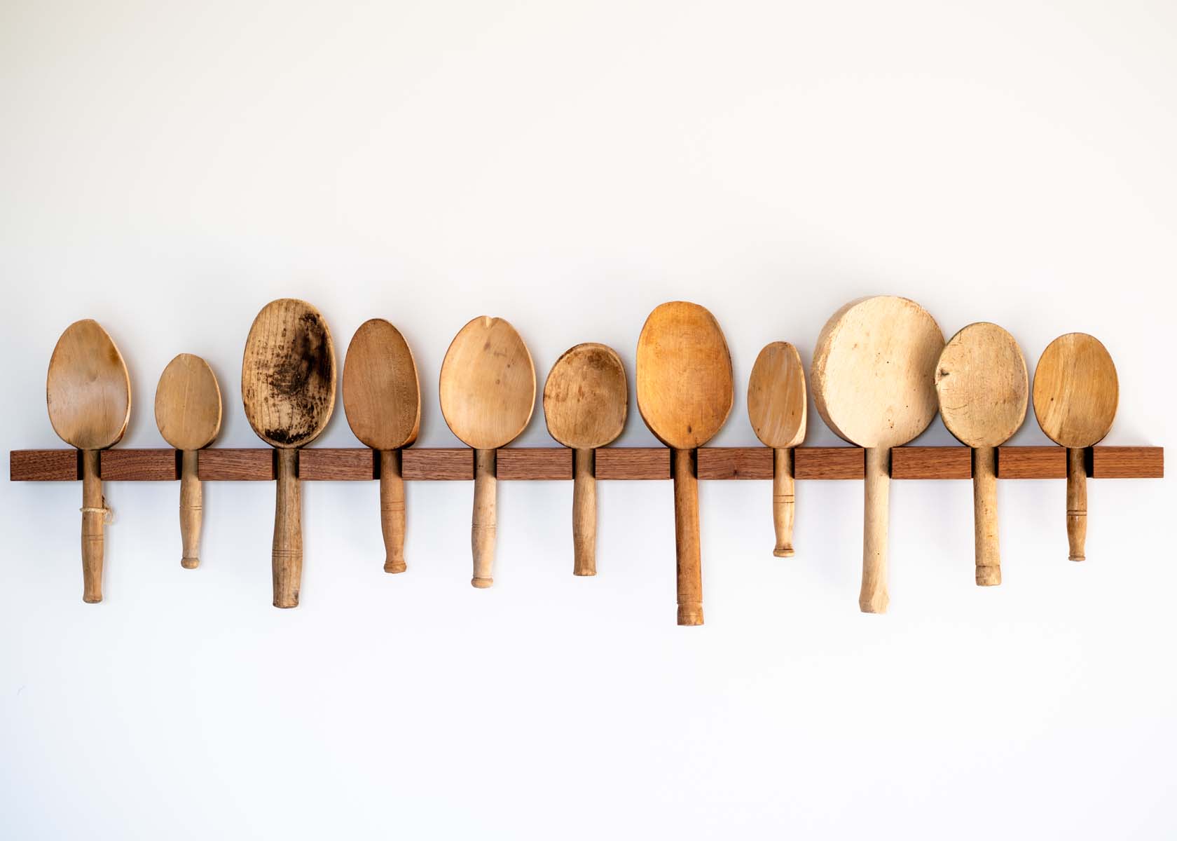A rack of wooden spoons
