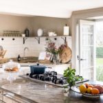 Kitchen with large marble top island and French doors