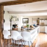 Large kitchen with oak beams, low ceiling and large island with marble top