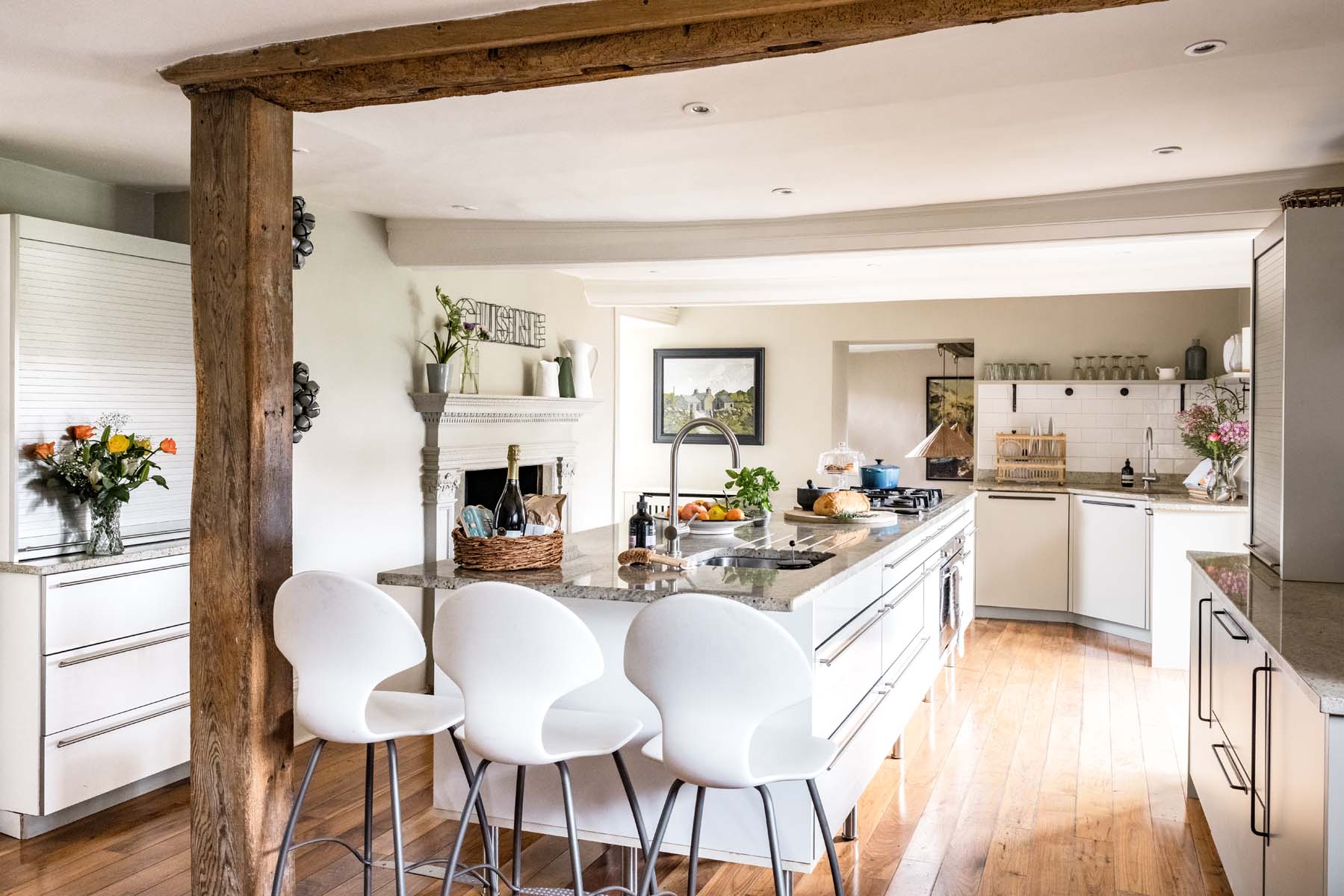 Large kitchen with oak beams, low ceiling and large island with marble top