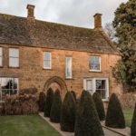 Country house exterior with front garden with a topiary lined path