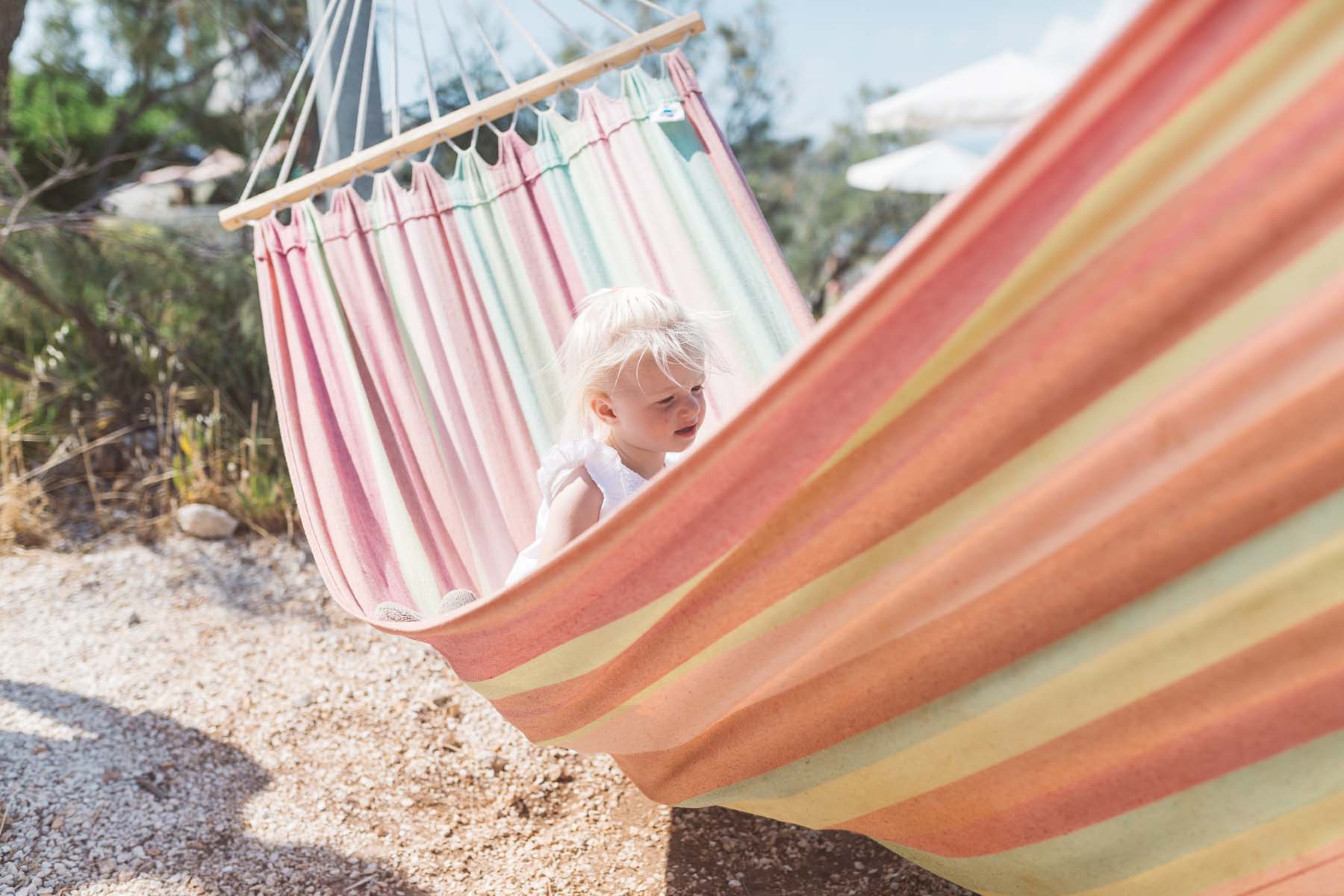 Young girl in a pink hammock