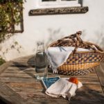 Picnic basket outside on a wooden table