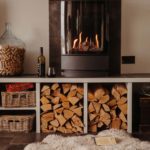 Modern wood burning stoves with logs stored in cubby holes