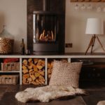 Modern wood burning stove with logs in a cubby hole