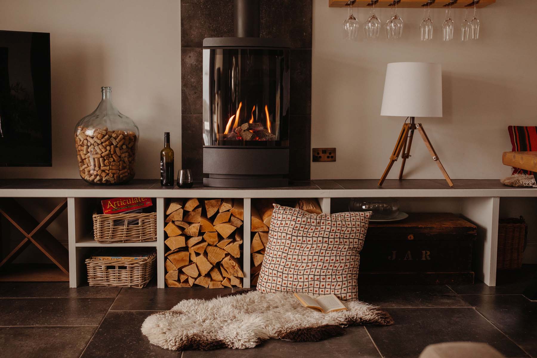 Modern wood burning stove with logs in a cubby hole