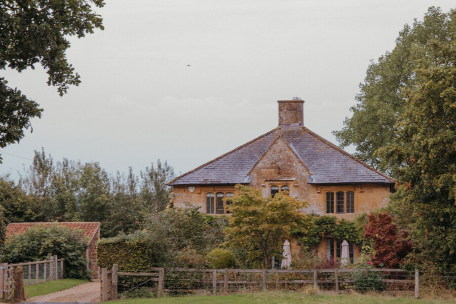 A winding pathway leading to a pretty country house