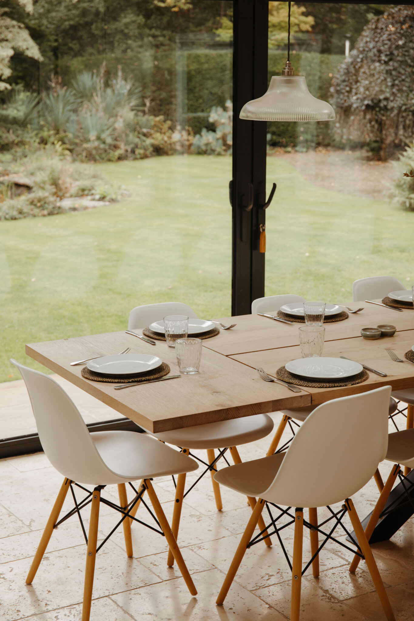 Dining table looking on to the garden through large glass windows
