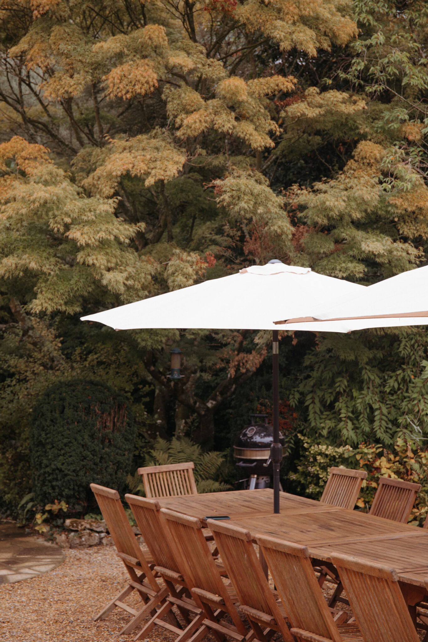 Wooden outdoor dining set with white parasols