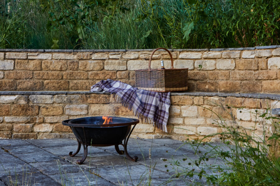 fire pit with picnic basket and blanket
