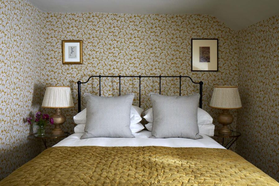 mustard floral double bedroom with iron bed frame
