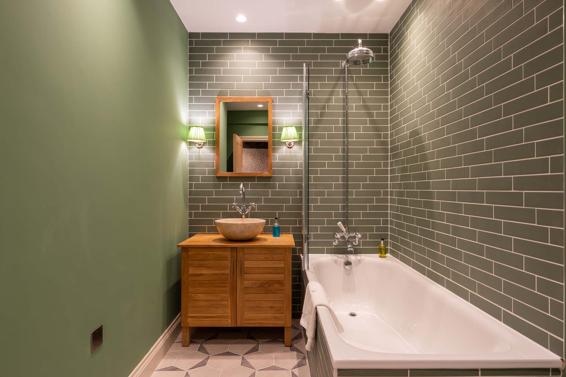 Bathroom with green tiles and bath/shower
