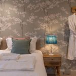 Large en-suite bedroom with floral wallpaper