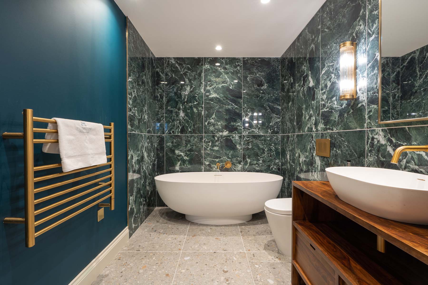 Large bathroom with standalone tub and green tiles