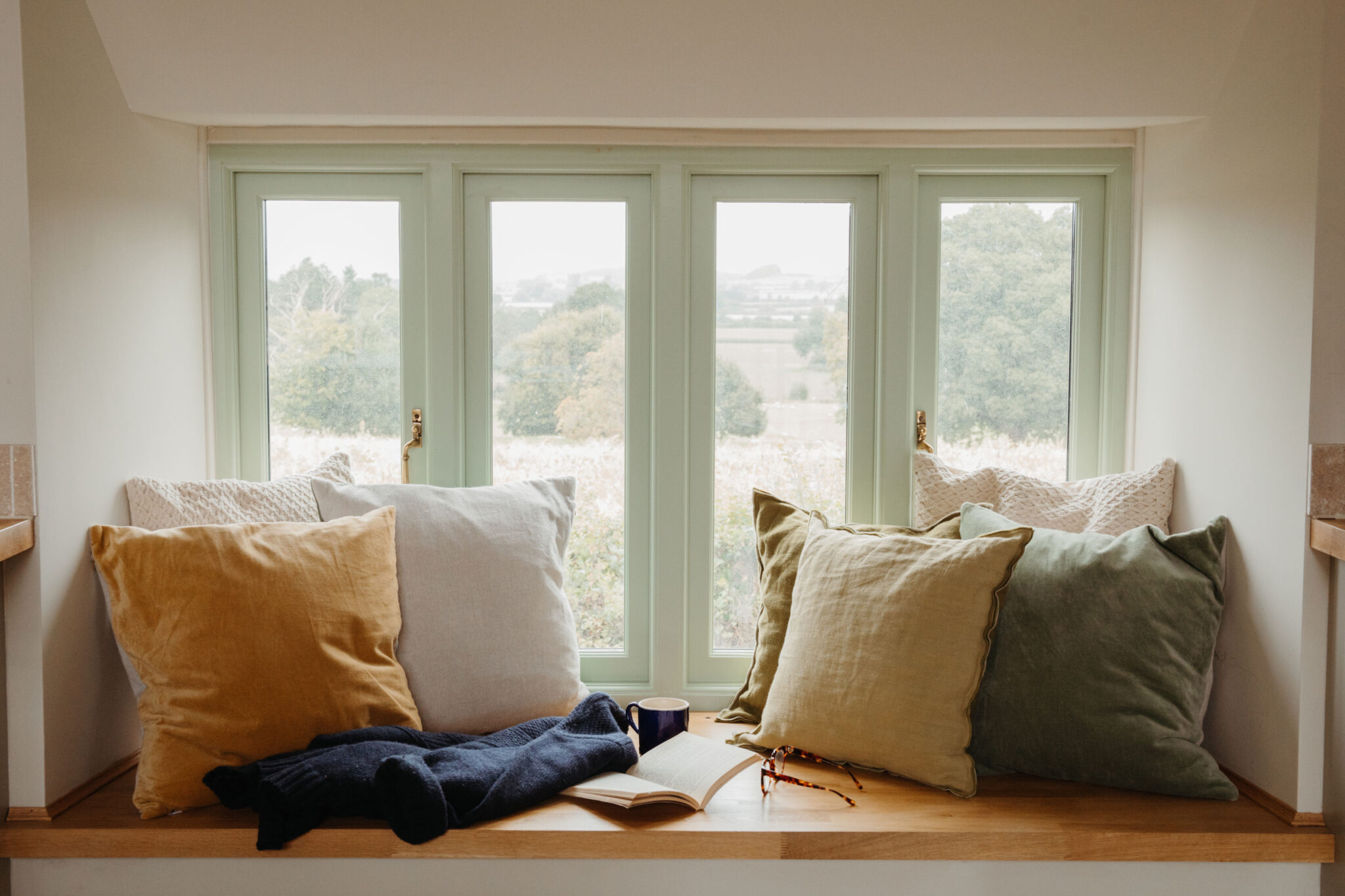 Cosy window seat with cushions overlooking the Somerset countryside