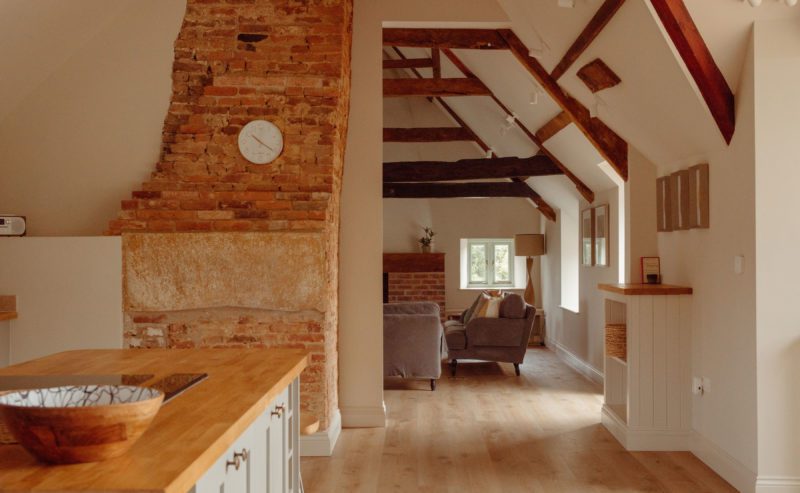 Kitchen and living area in a large country house with wooden beams