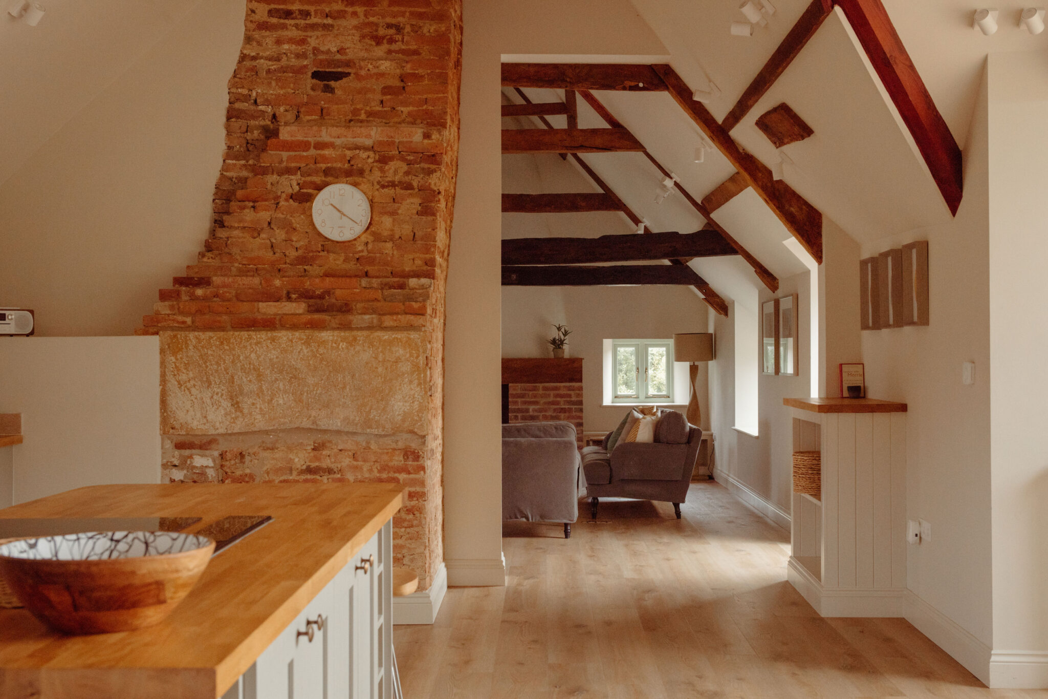 Kitchen and living area in a large country house with wooden beams