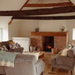 Sitting room with fireplace and wooden beams