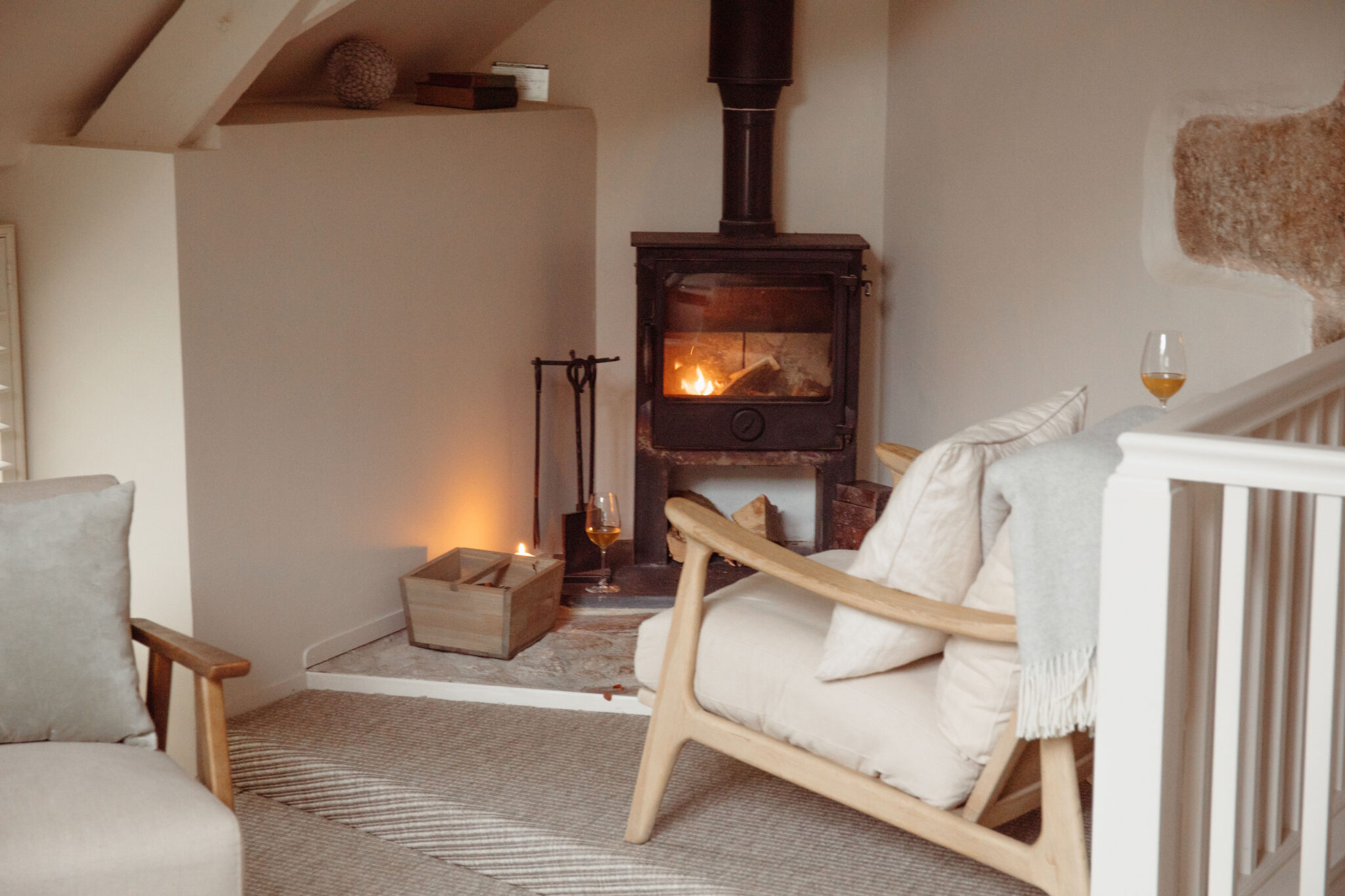 Cosy white armchair by the fire