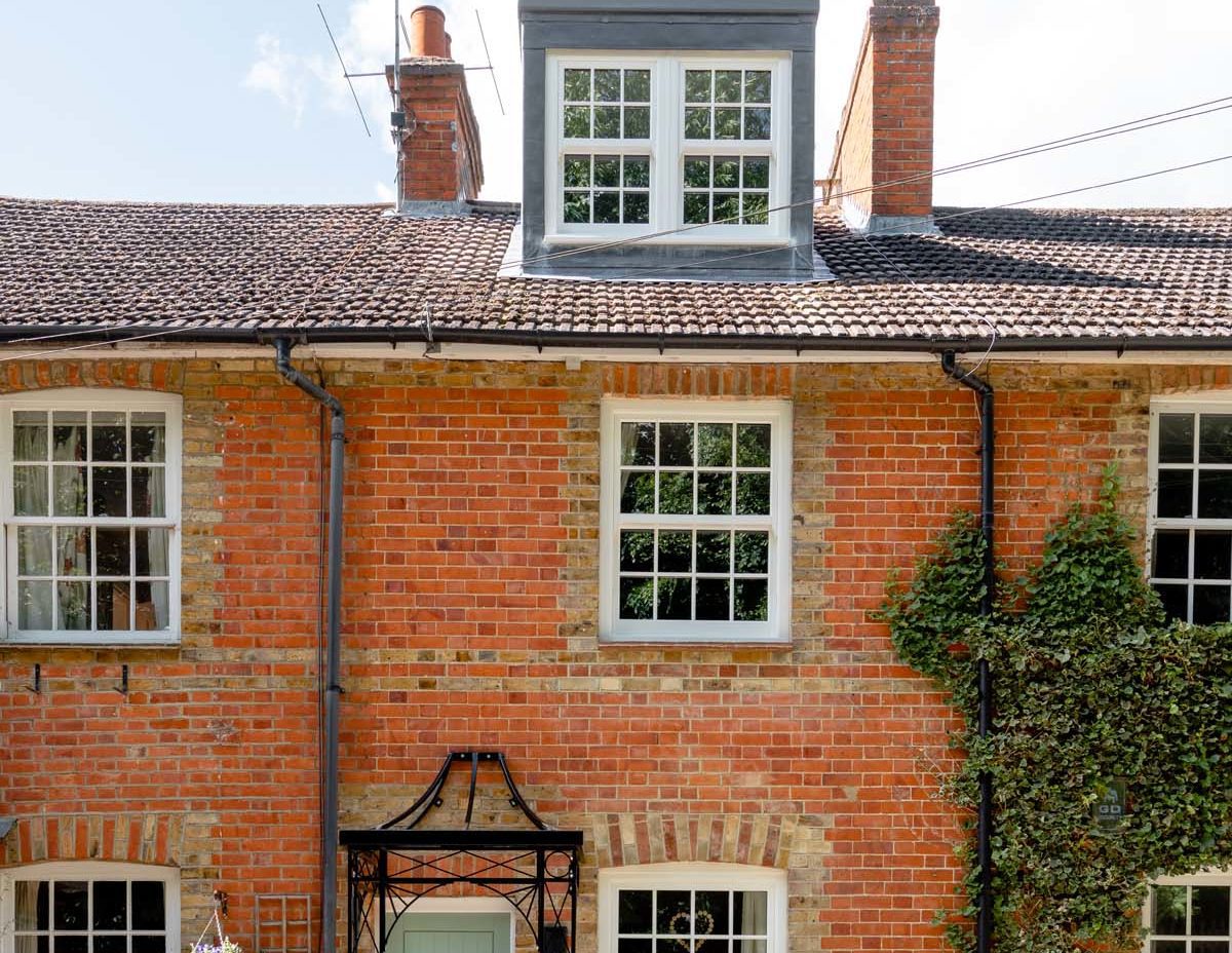 front exterior of red brick cottage