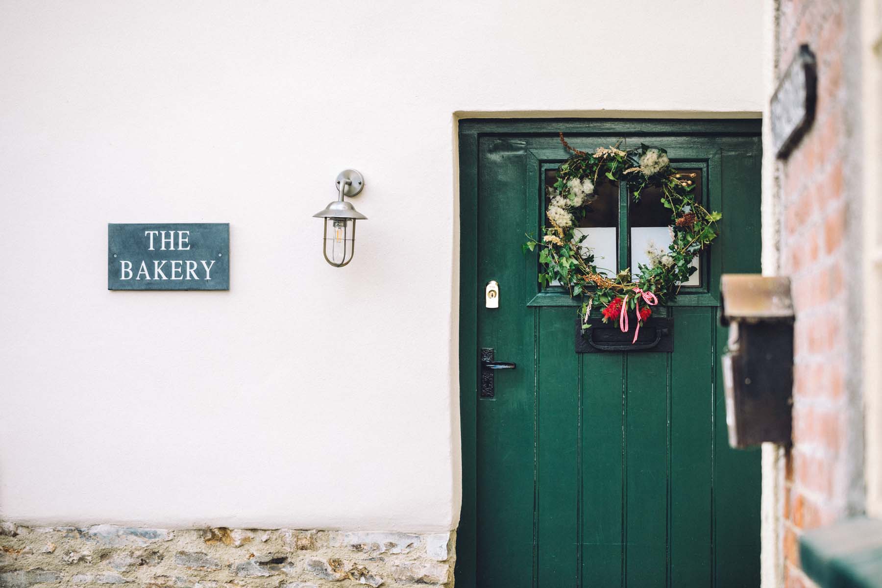 Pretty cottage with a green door and Christmas wreath