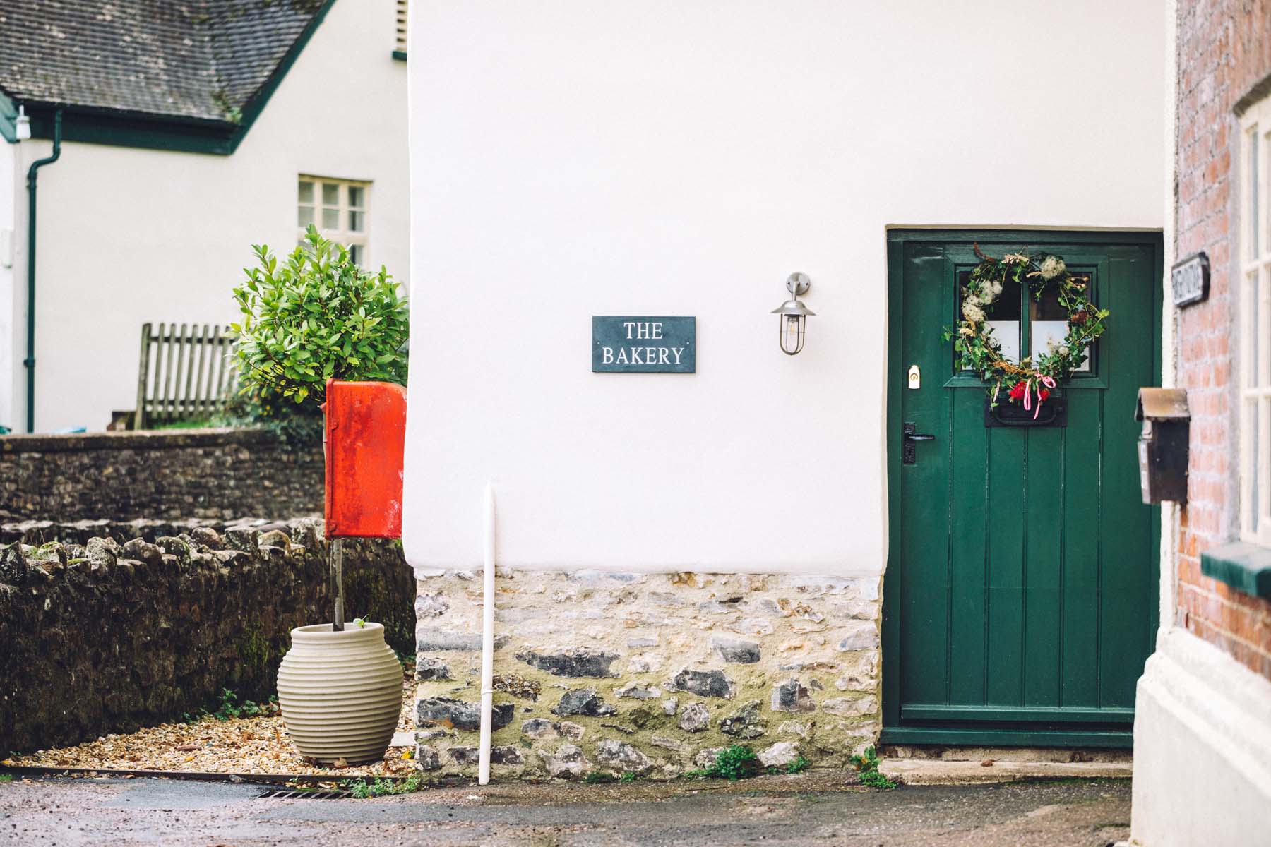 Pretty cottage with a green door and Christmas wreath