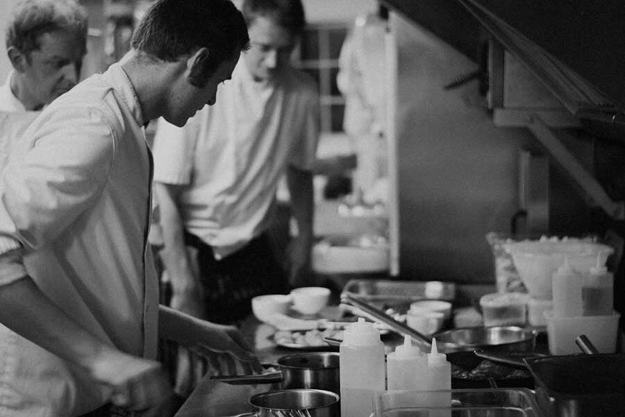 Two chefs cooking in a kitchen.