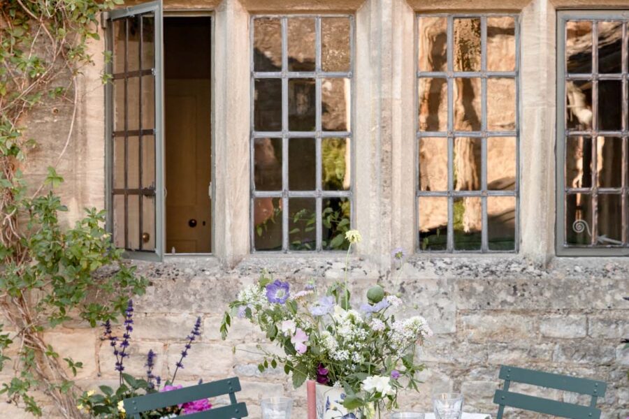 Outdoor summer tablescape with flowers and fresh fruit