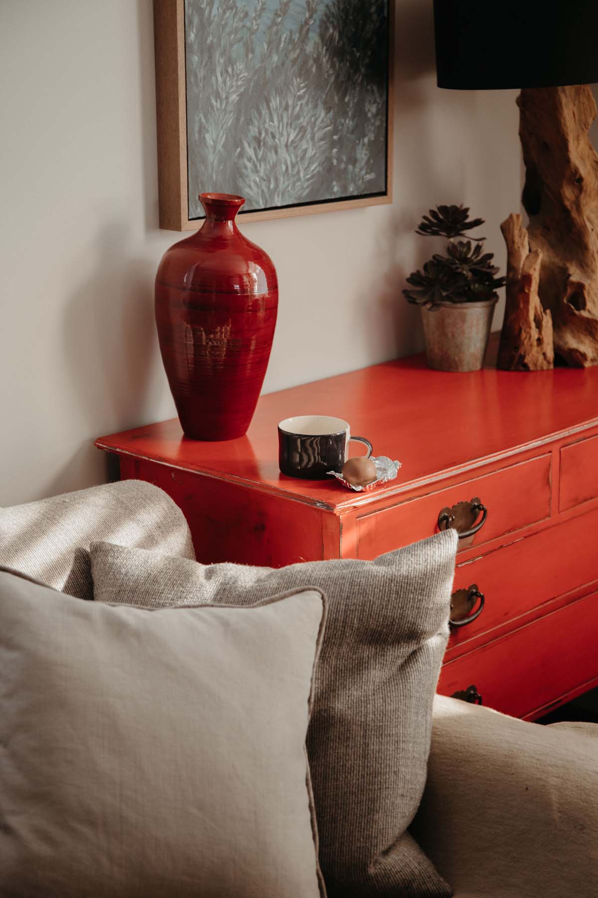 Red vase on a red cabinet