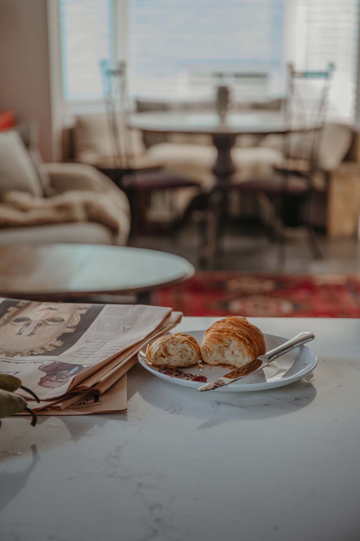 Croissant and newspapers on the kitchen counter