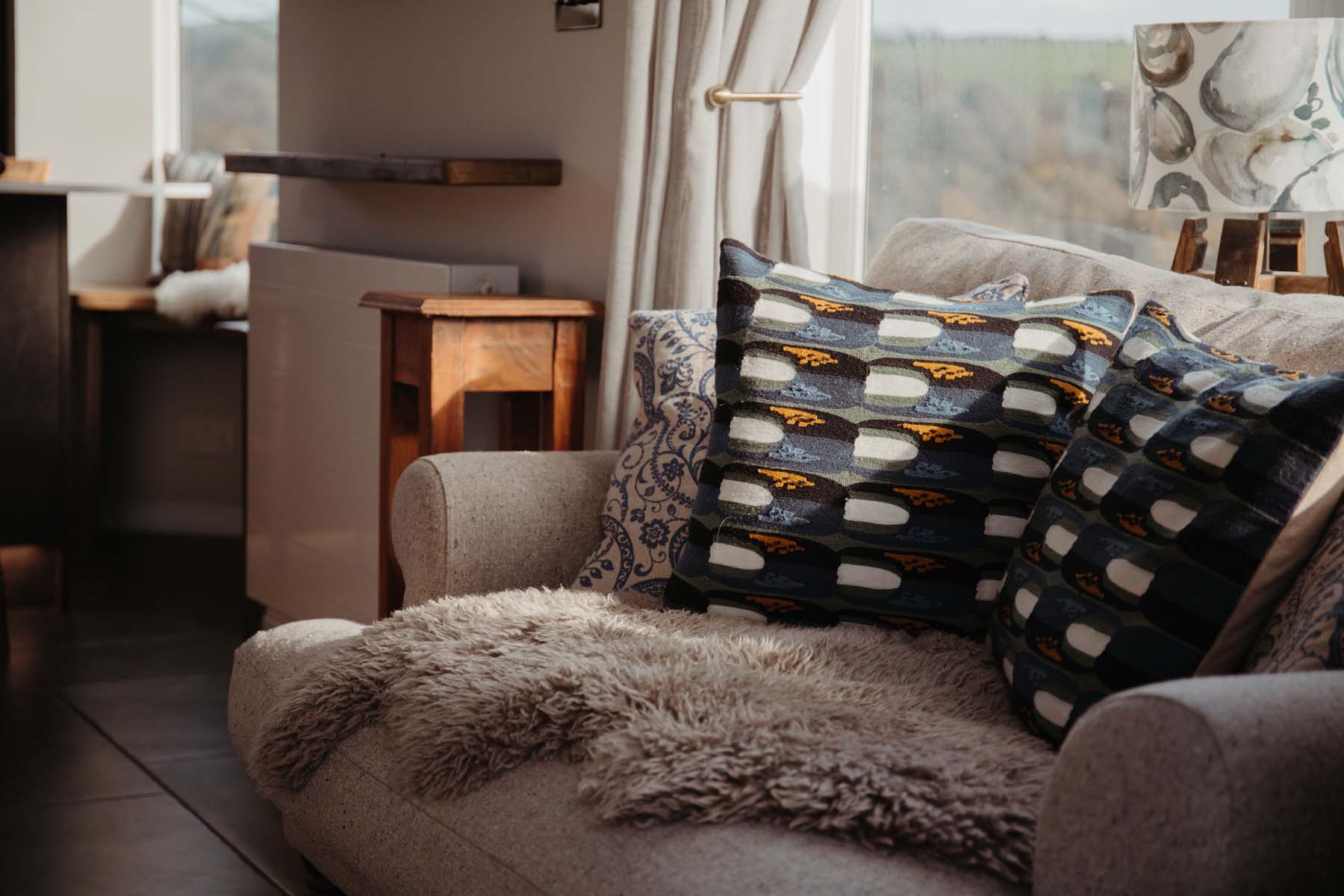 Cosy sofa with shearling and patterned cushions